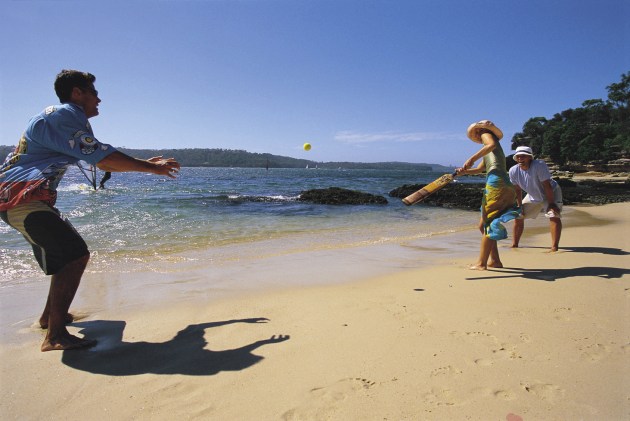 Combining beach with a cricket bat and a tennis ball